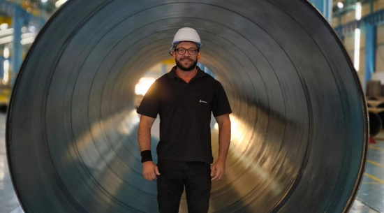 Man standing in front of water pipe